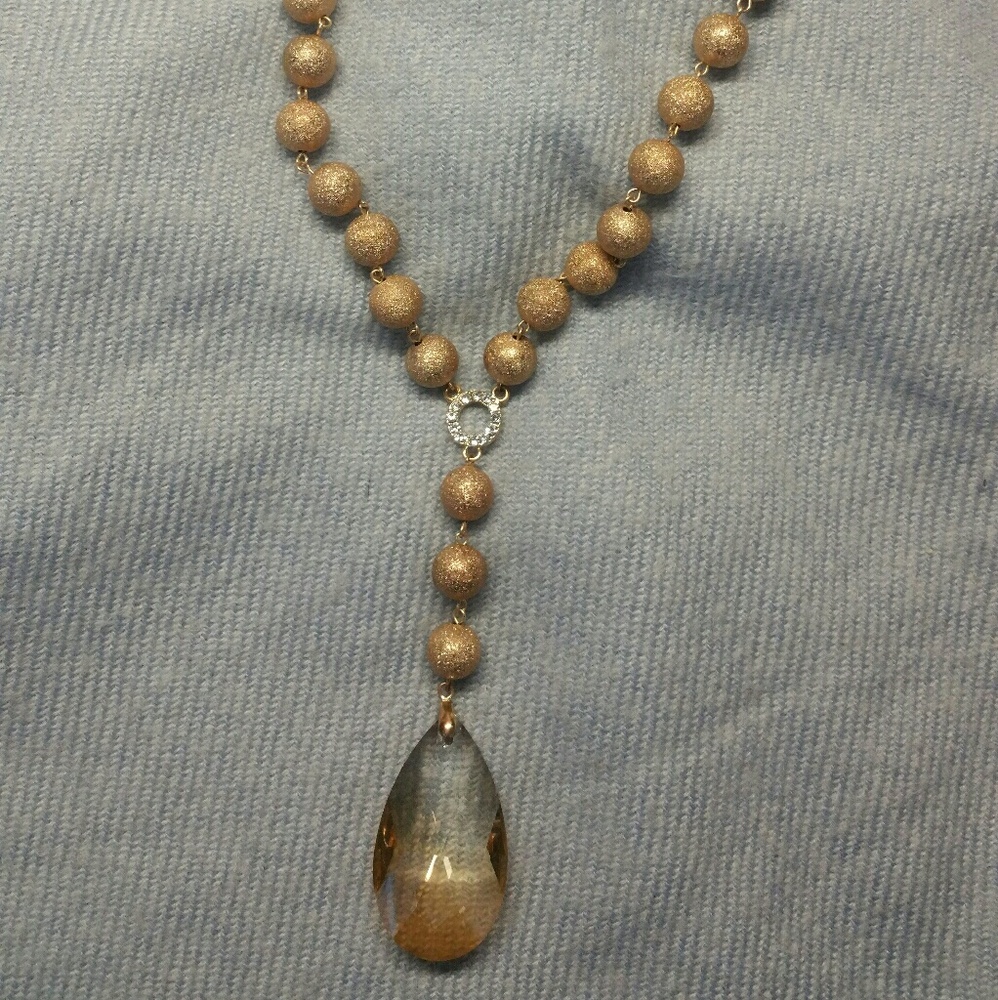 Sparkly gold necklace with cut glass.